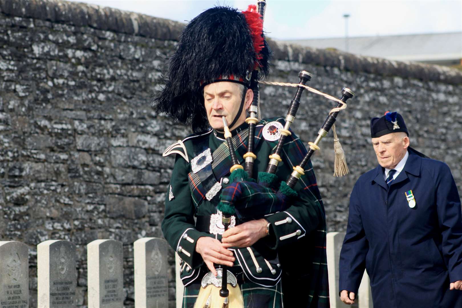 Pipe Corporal Gordon Tait, of Wick RBLS Pipe Band, followed by Alex Paterson, chairman of the Wick, Canisbay and Latheron branch of the Royal British Legion Scotland. Picture: Alan Hendry
