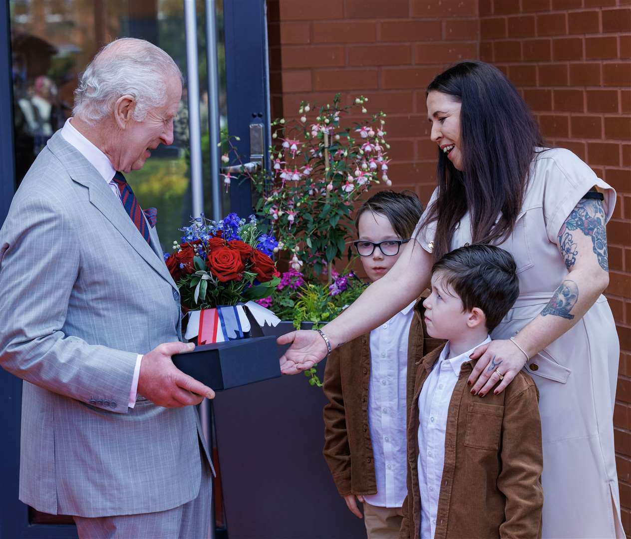 Charles receives gifts of flowers and Royal Engineer china mugs from the children of some of the barracks’ serving soldiers (Jonathan Buckmaster/Daily Express/PA)