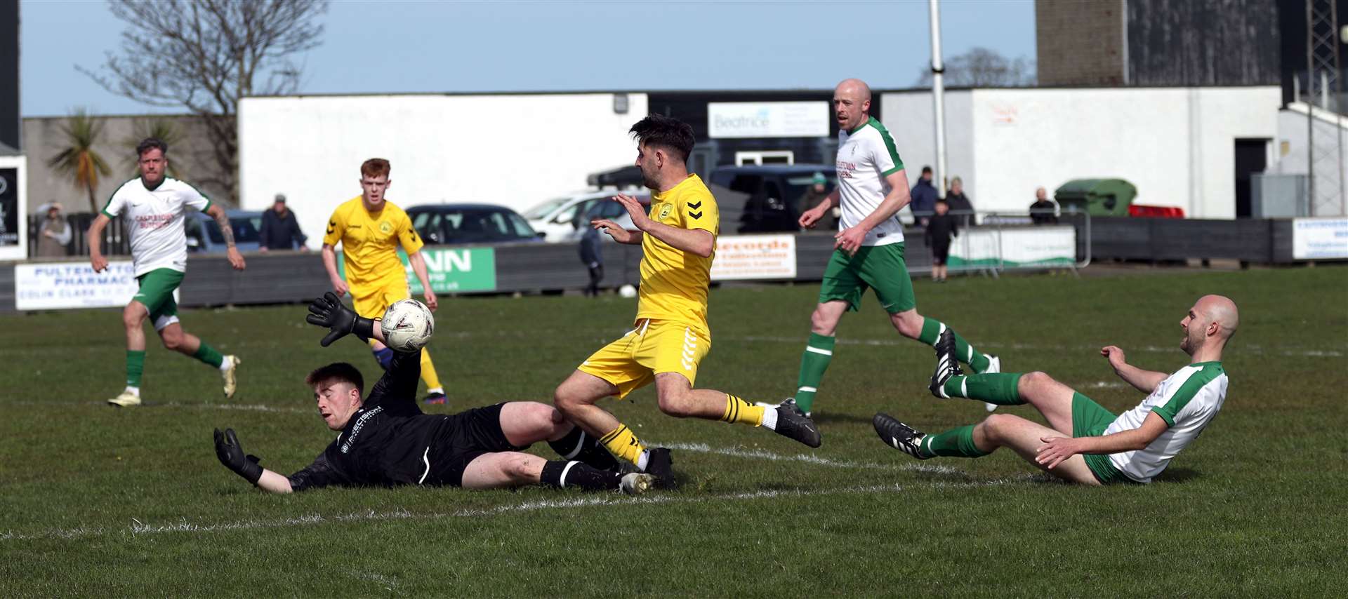 Castletown goalkeeper Ewan Grant makes a save from Staxigoe United striker Graham MacNab. Picture: James Gunn