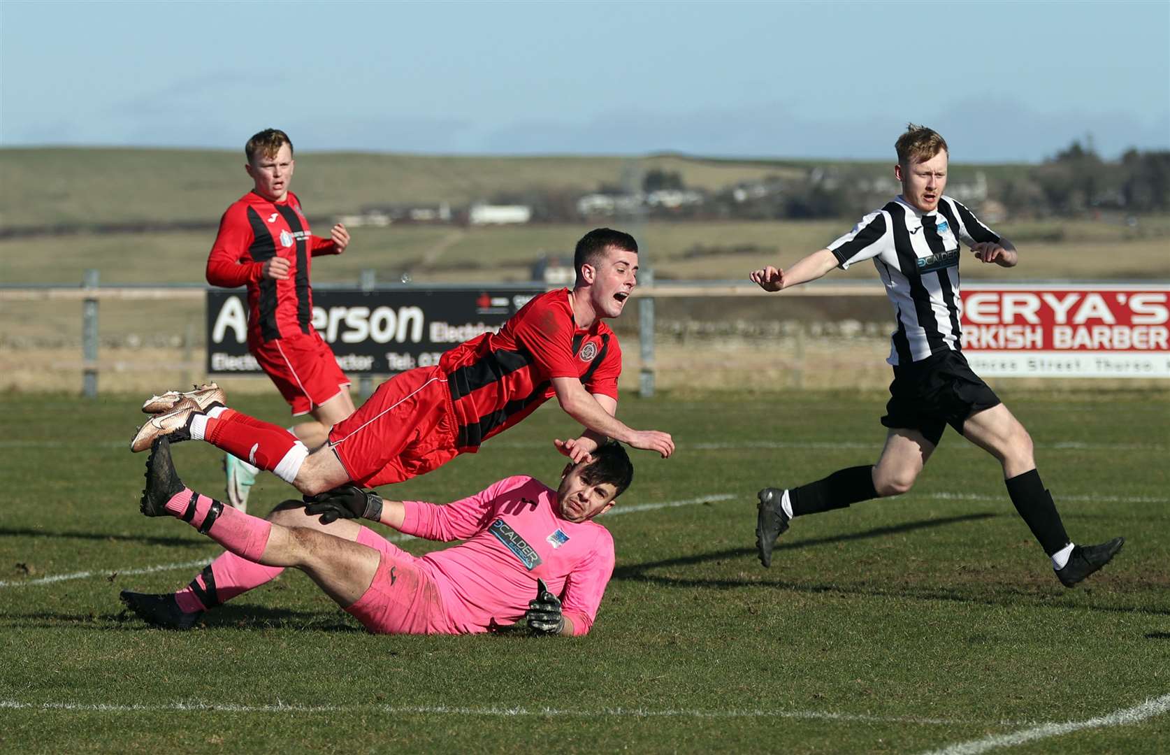 Halkirk United's Grant Aitkenhead appears to be felled by Alness keeper David Sienkowski but no foul was given. Picture: James Gunn