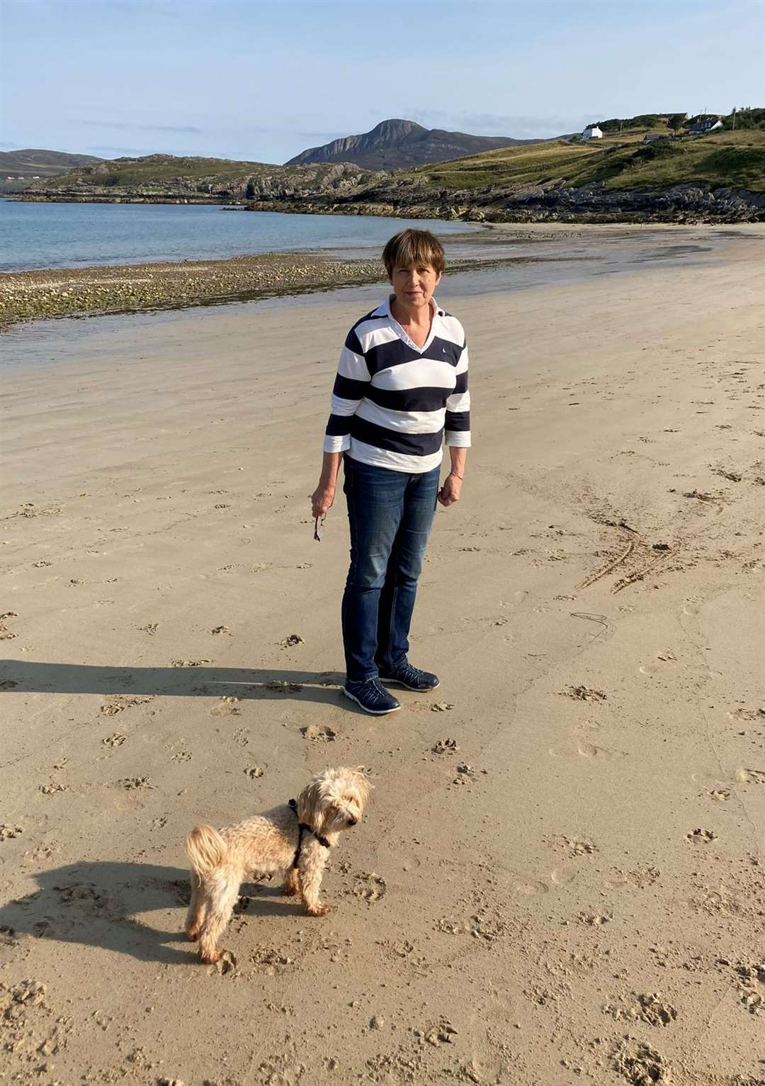 Moira at Talmine beach in 2021 with Arlo the Maltipoo.