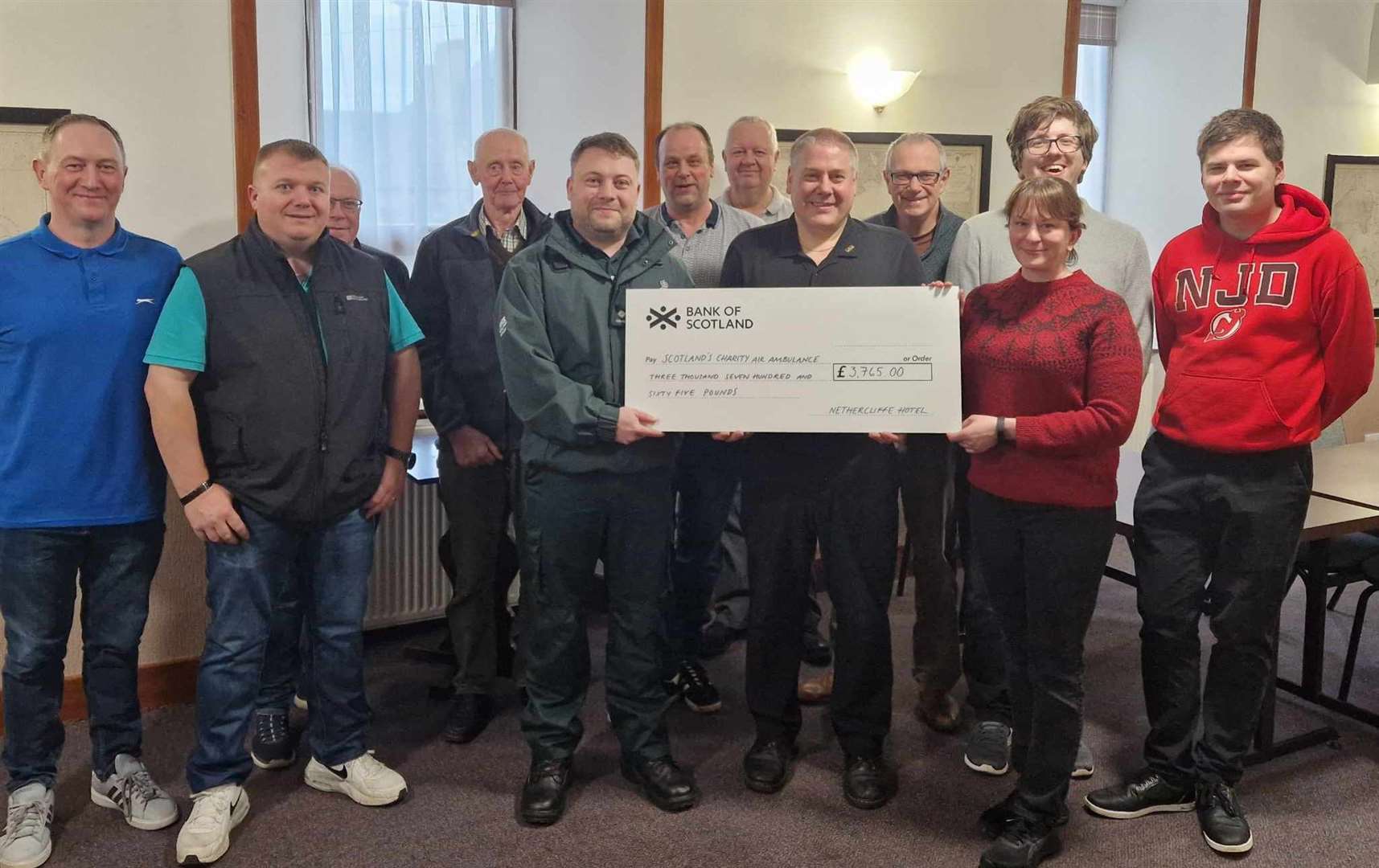 From left to right, Eifion Davies, George Duncan, Peter Gunn, David Forbes, Dominic Rigby, Kenneth Forbes, John Taylor, Mervyn Hill, Martin Duffy, Michael Hill, Ruth Falconer, Adam Hill as the Nethercliffe Hotel hands over a cheque to Scotland's Charity Air Ambulance.