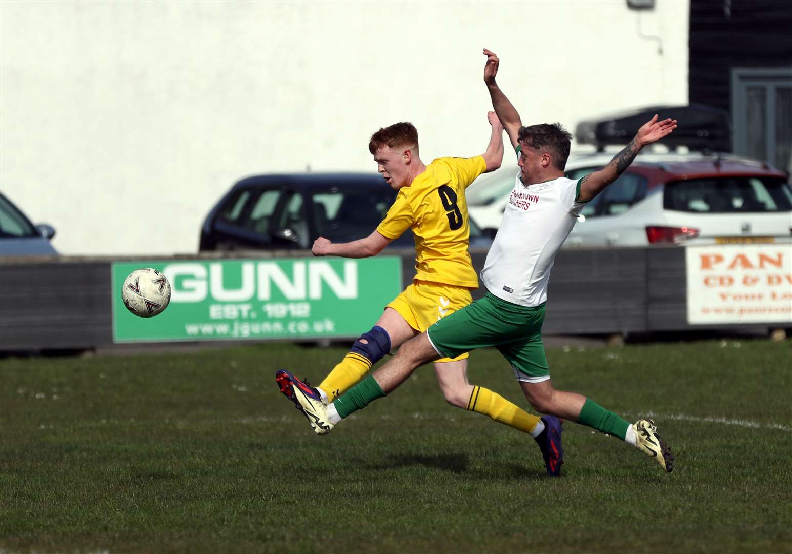 Staxigoe United's Morgan Kennedy gets a shot in despite a challenge from Castletown's Lewis Gow. Picture: James Gunn