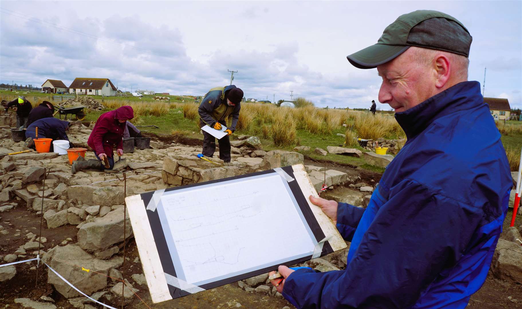 Chris McNeill showing a cross-section of the building's remains. Picture: DGS
