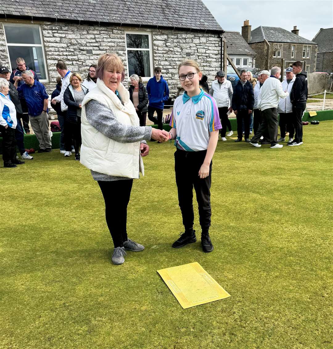 Lybster club president Fran Manners presenting the first jack to the club’s youngest member, Mhairi Kirk. Picture: Tony Draper-Rickards
