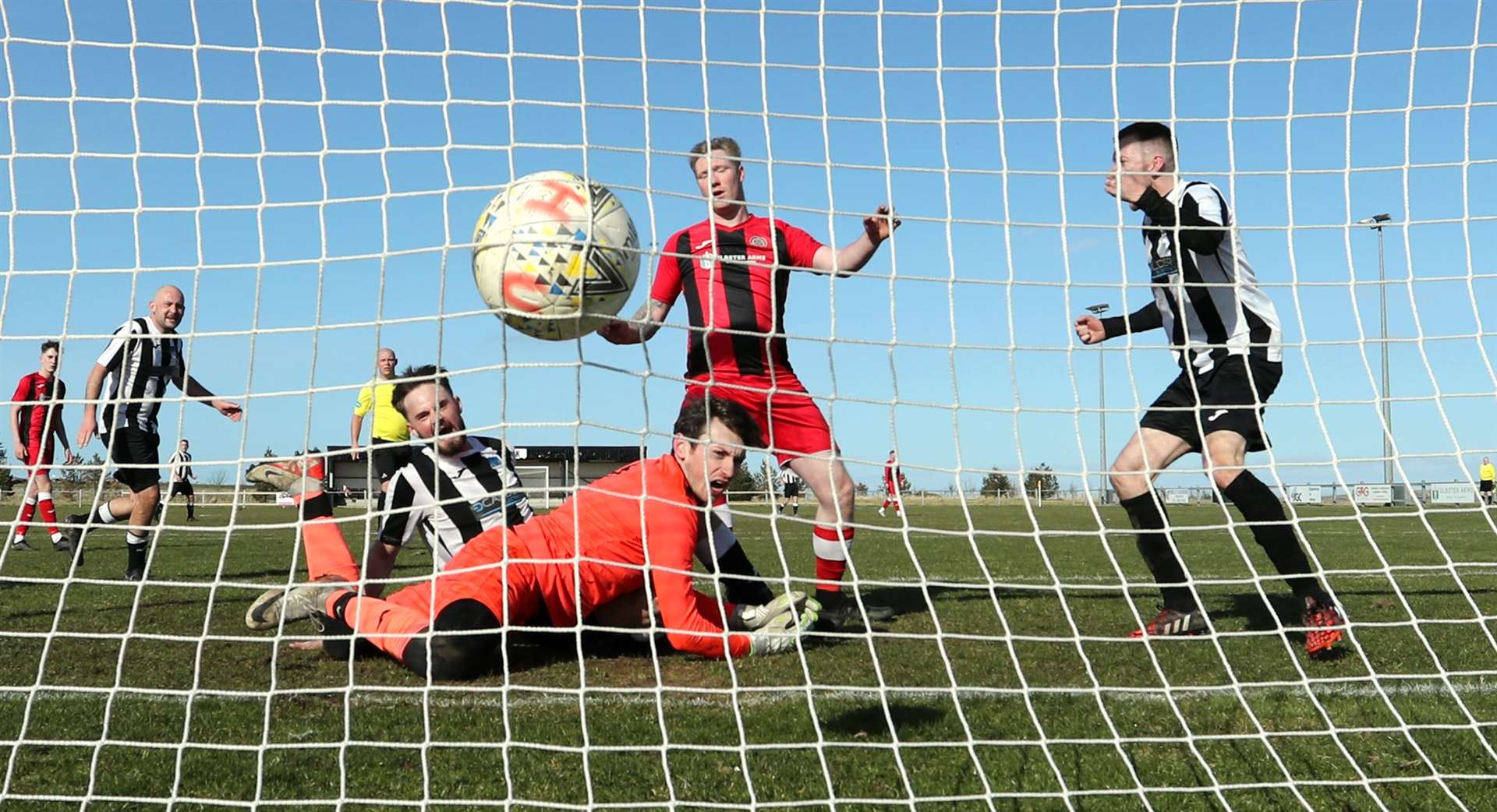 Joel Burnett squeezes the ball past Halkirk United keeper Kieran Macleod for Alness United's first goal at Morrison Park. Picture: James Gunn