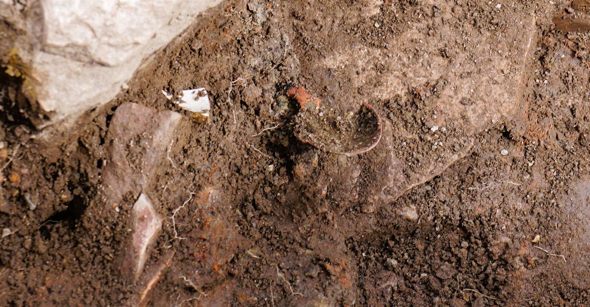 Part of a spoon can be seen at centre emerging from the soil. Picture: DGS