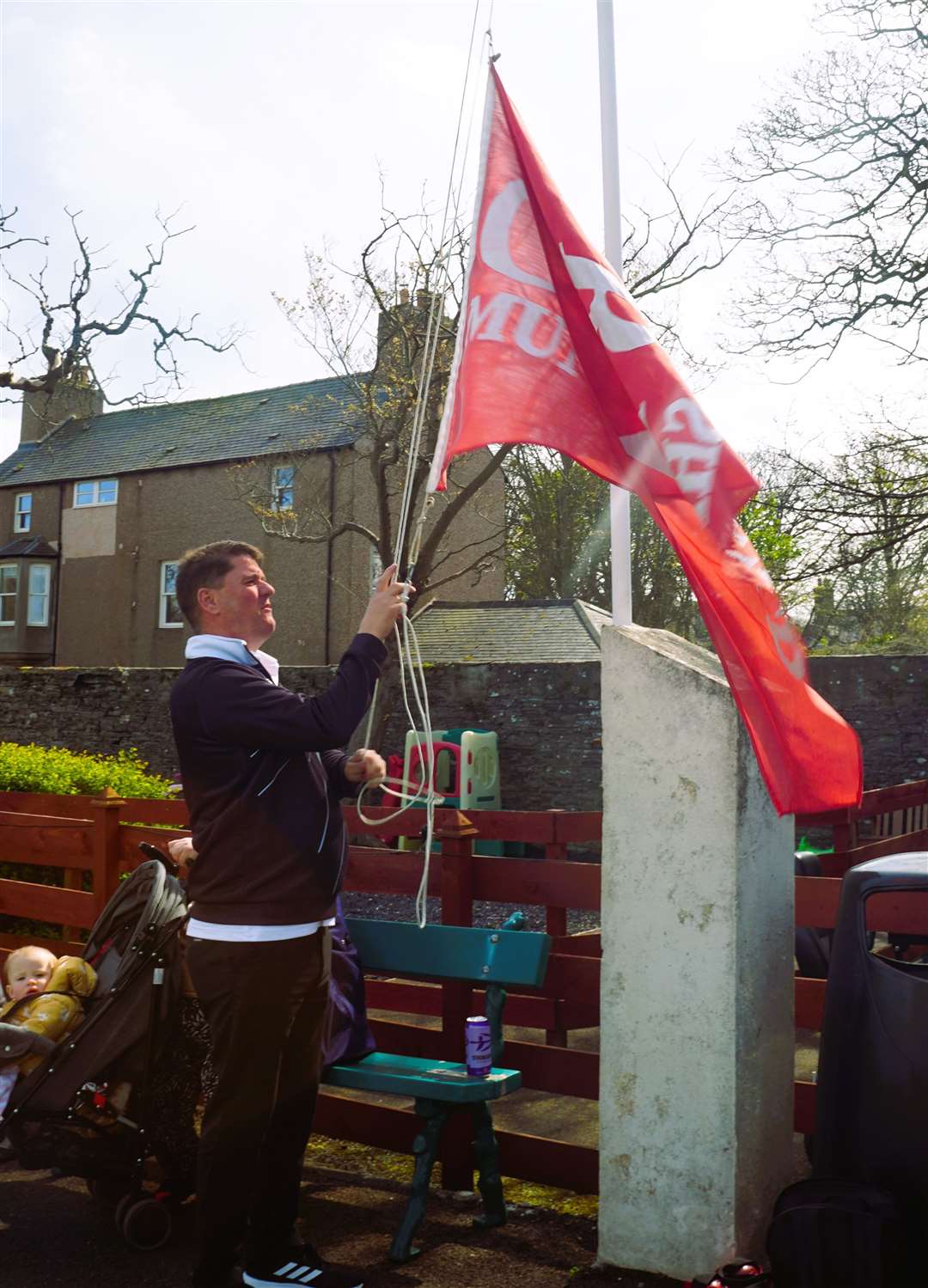 Graham raises the Munro Shield flag to highlight that the club won this accolade over the last season. Picture: DGS