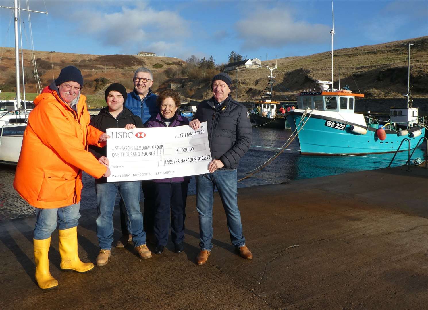 Willie Watt (centre), chairman of the Seafarers Memorial Group, and Andrew Bremner (right), one of the group’s patrons, receiving the Lybster Harbour Society cheque from Stevie Gunn (left), James Stewart and Tye MacDonald.