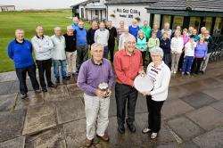 Margaret Sinclair, winner of the ladies’ section of Wick Golf Club’s annual veterans’ competition, receives her trophy from Rob Sutherland, of sponsors D. Sutherland & Son, while looking on is men’s section winner, Harry Cormack. Also in the photograph ar