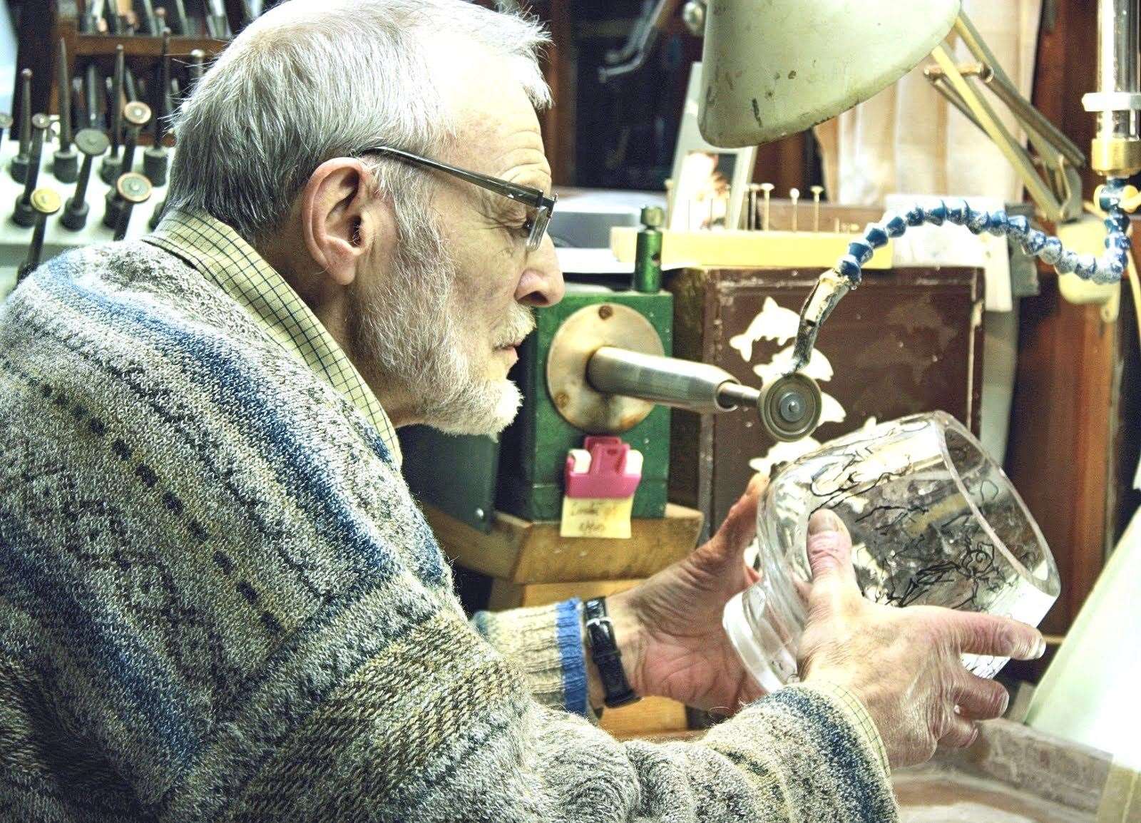 Denis Mann engraving in his studio.