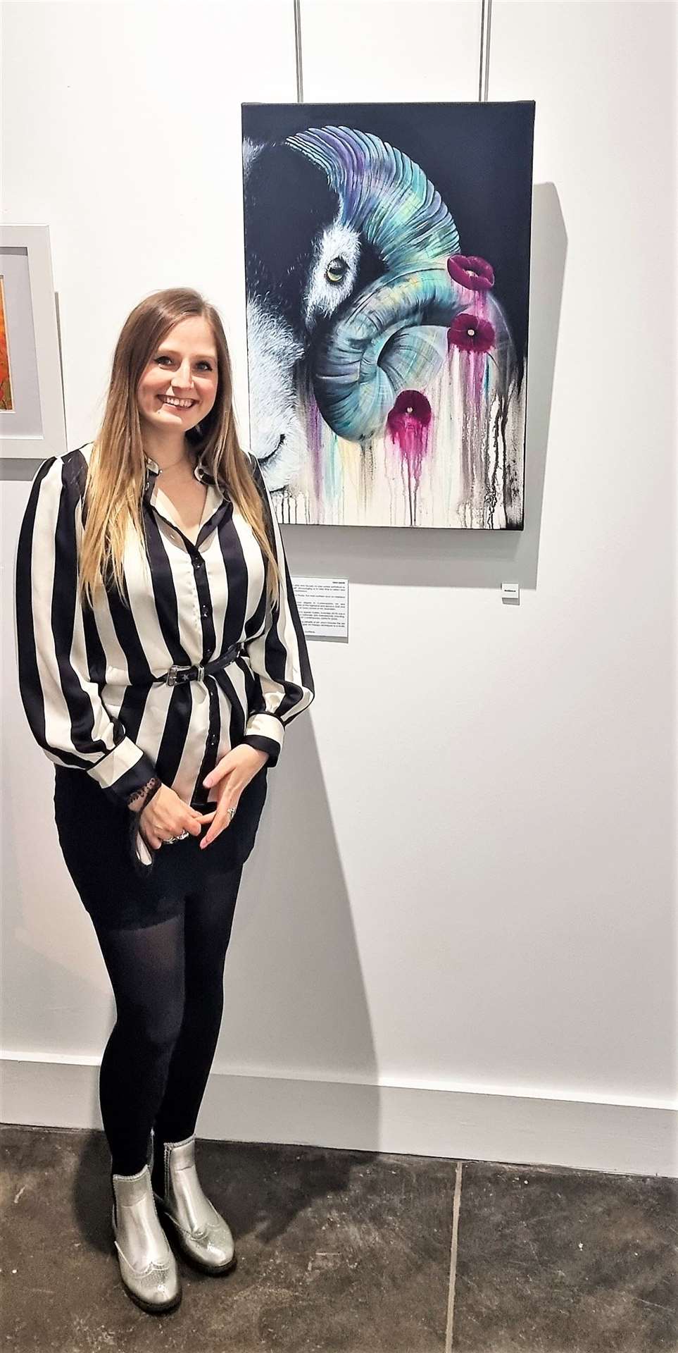 Leah Davis with her painting called Resilience.