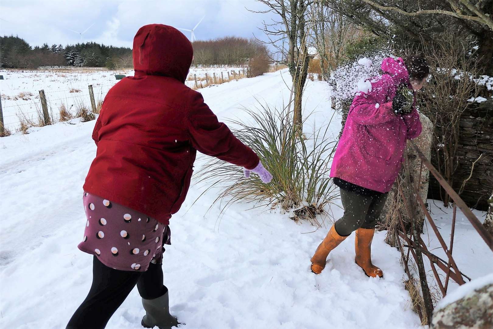 Two local primary school teachers enjoy the day off with a snowball fight. Picture: Virginia Crow