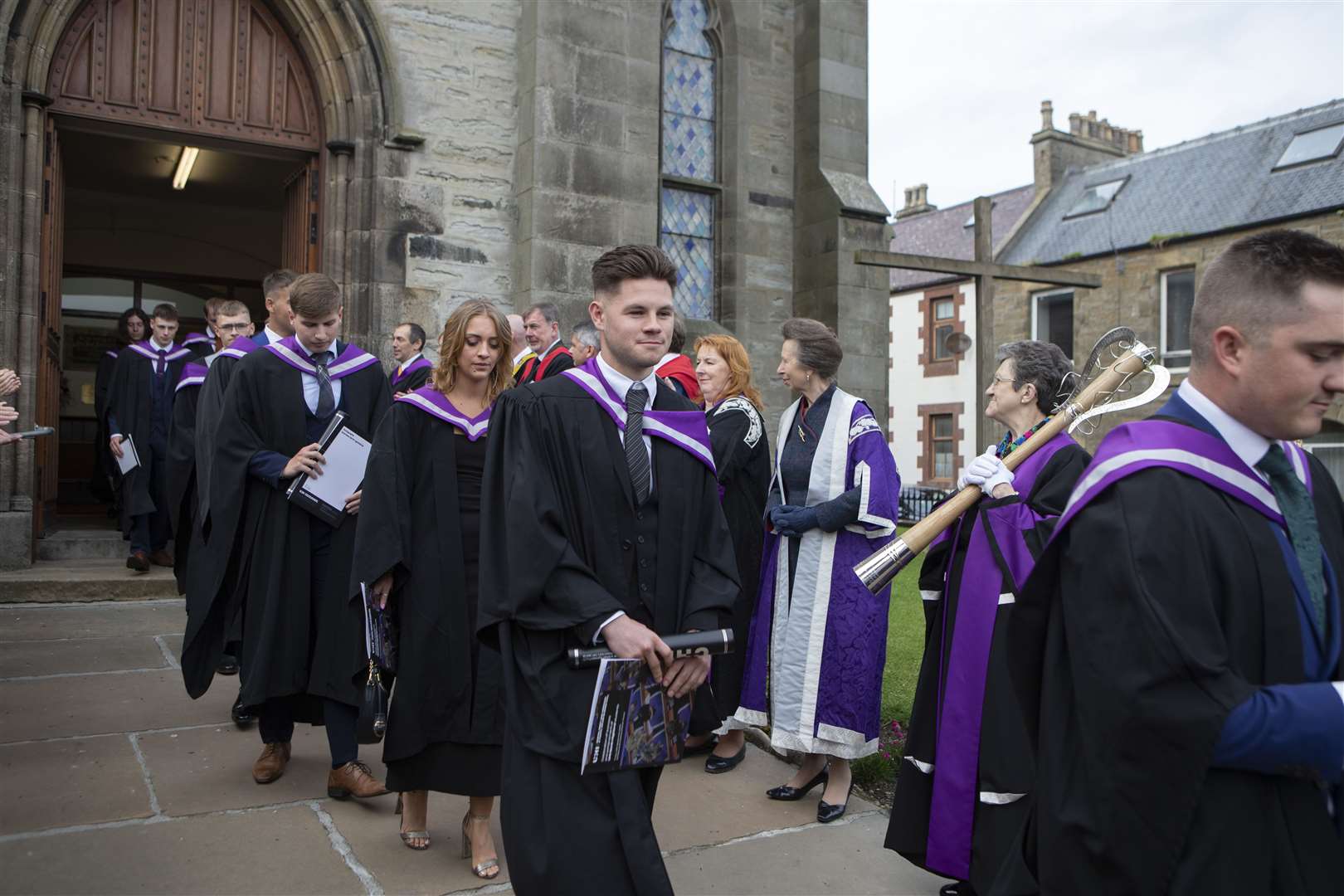 The graduates file past Princess Anne as they leave the church.
