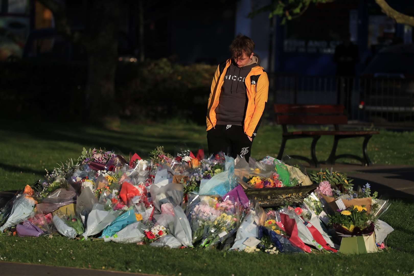 Patrick James, the son of PCSO Julia James, looks at floral tributes left near her family home in Snowdown, near Aylesham, Kent (Gareth Fuller/PA)