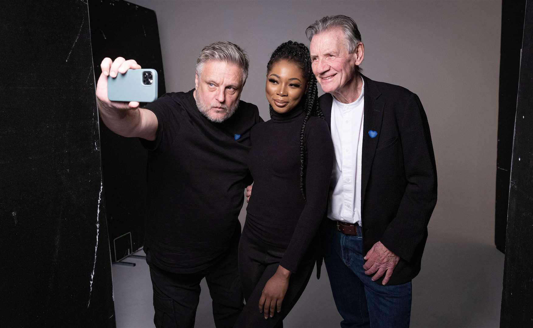 Nafisat Ibrahim (centre), 25, from London and Michael Palin (right) during a photoshoot with Rankin (left) as part of a new exhibition led by NHS Charities Together (Matt Alexander/PA)