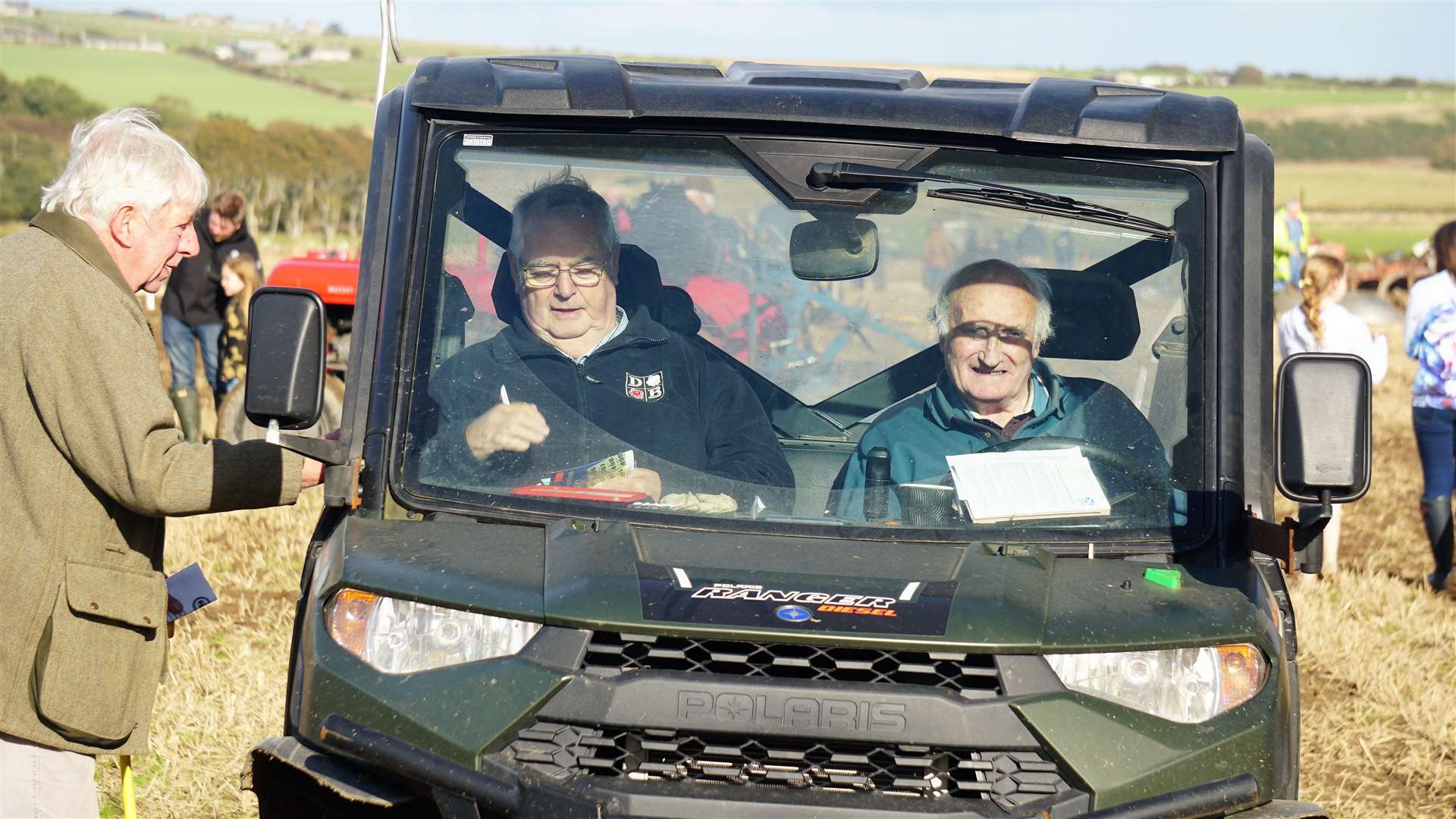 Will Gunn, left, and James Sinclair, drove around the field to sell charity raffle tickets on the day. Picture: DGS