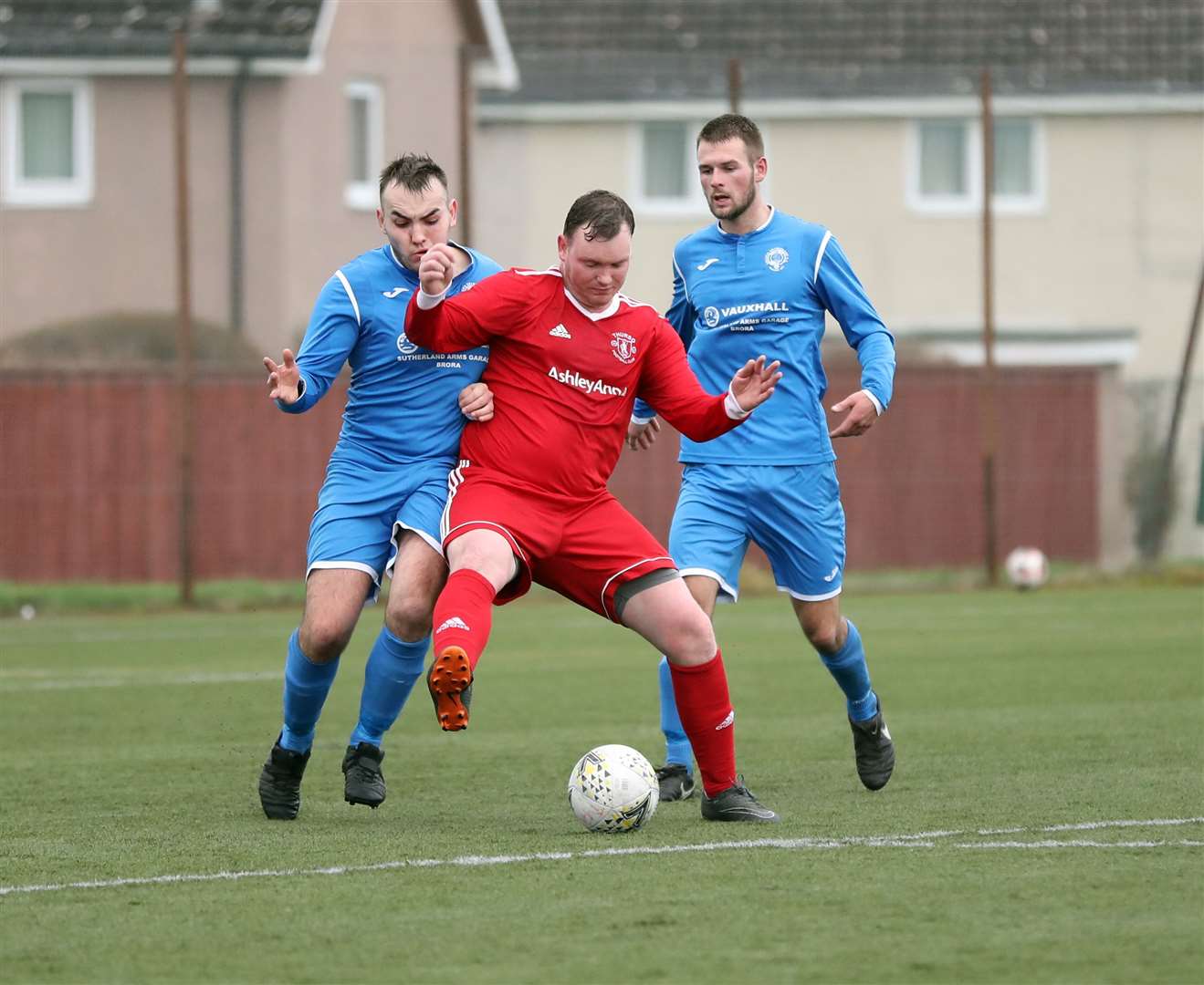 Thurso's James Murray shields the ball from Golspie Sutherland's Owen Harrold. The visitors' match-winner, Danny Coghill, looks on. Picture: James Gunn