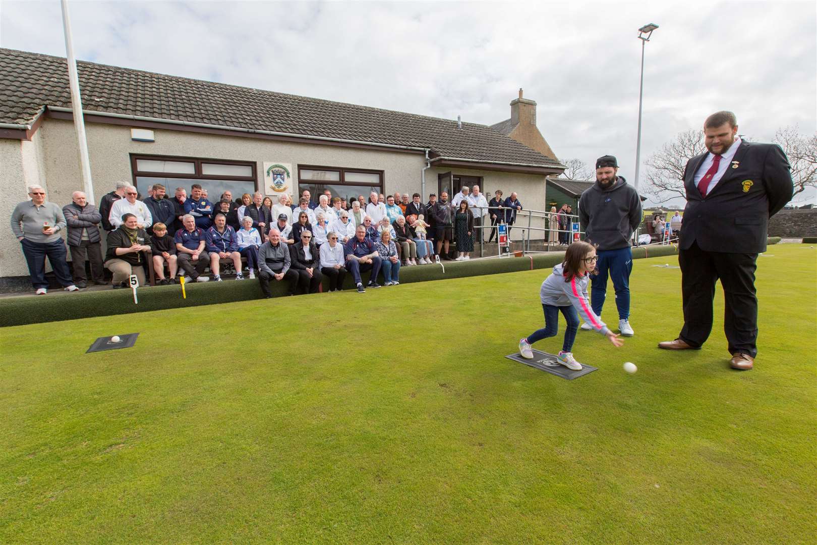 Scarlet throwing the first jack, watched by club president James Murray (right) and Scarlet’s father Daniel. Picture: Robert MacDonald / Northern Studios