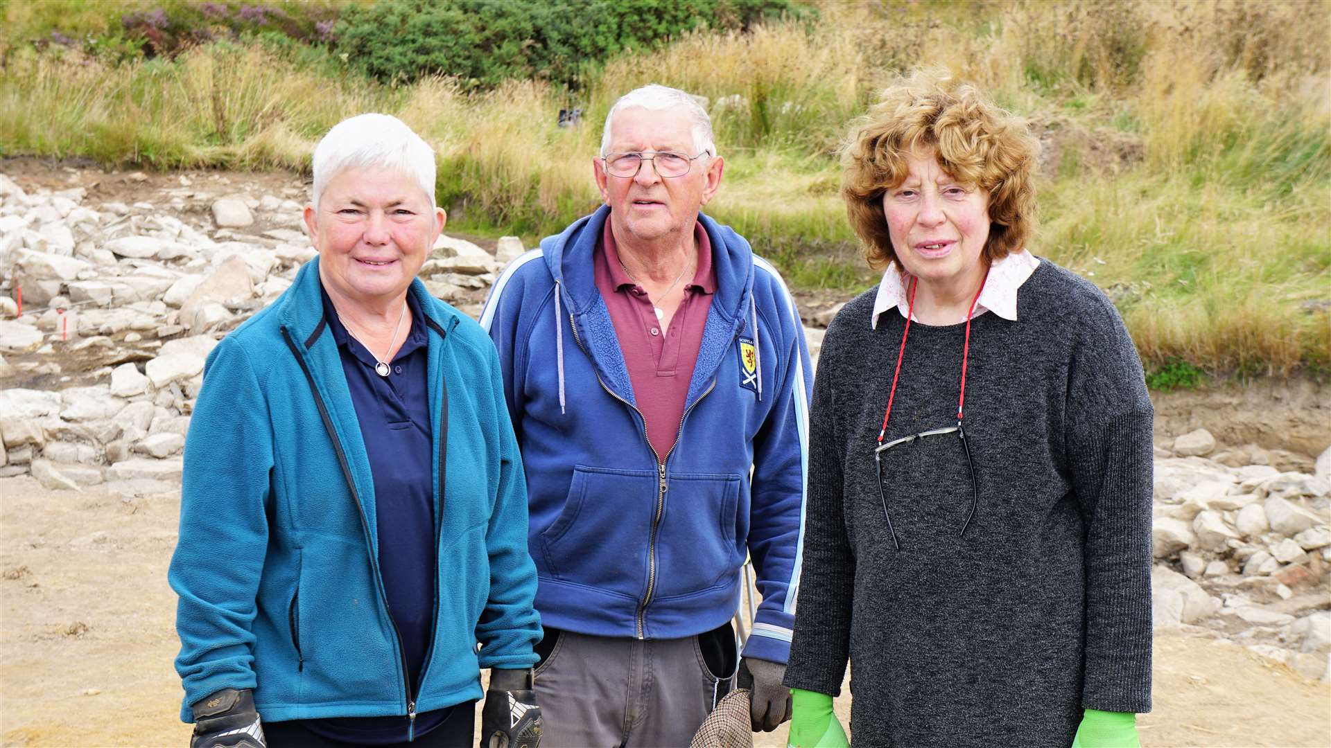 Volunteer husband and wife team Anthea and Deryck Deane stand next to Islay Macleod at right.
