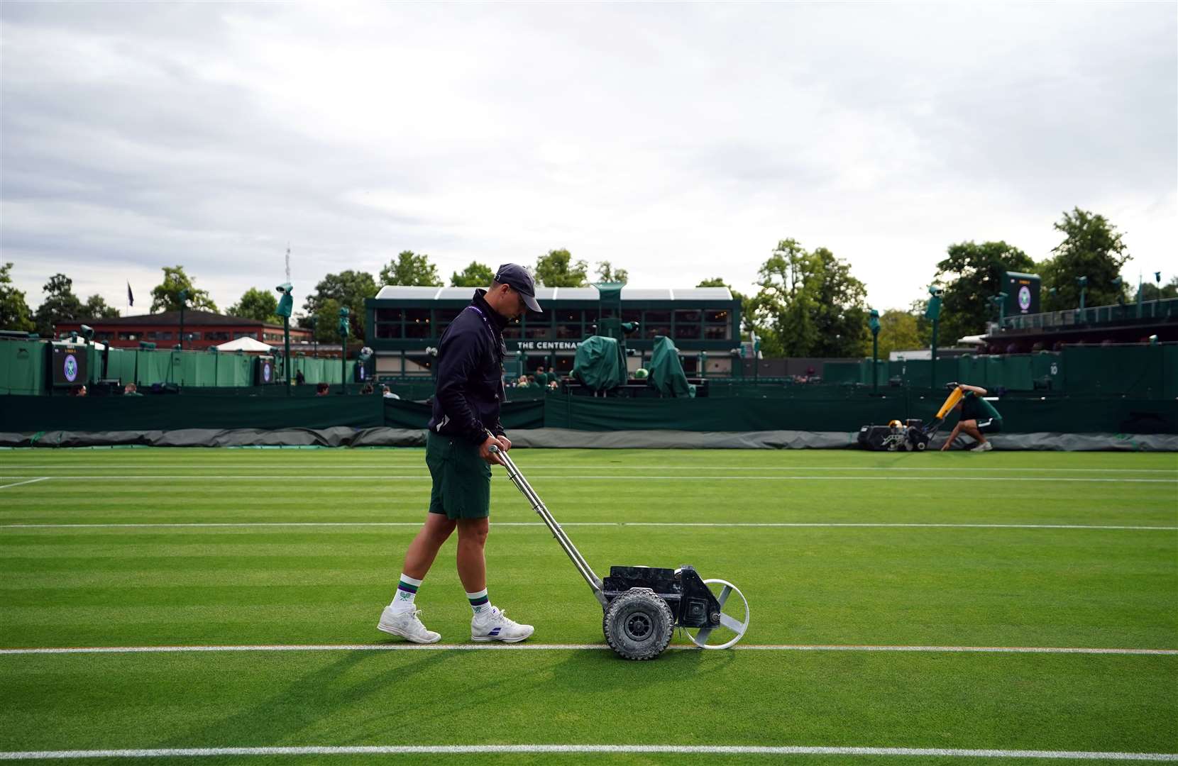 Ground staff prepare the courts on day two of the 2023 Wimbledon Championships (Zac Goodwin/PA)