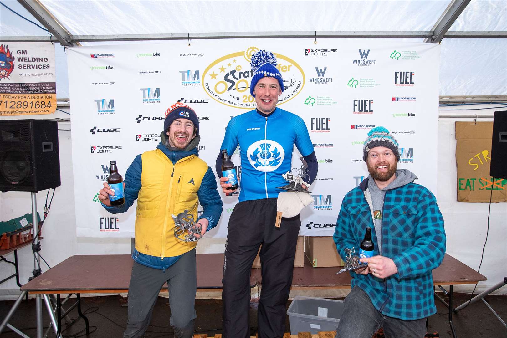 Robbie Mitchell (centre) celebrates winning Strathpuffer 2023 with Kyle Beattie (left) and Tom Simpson. Picture: Gary Willamson