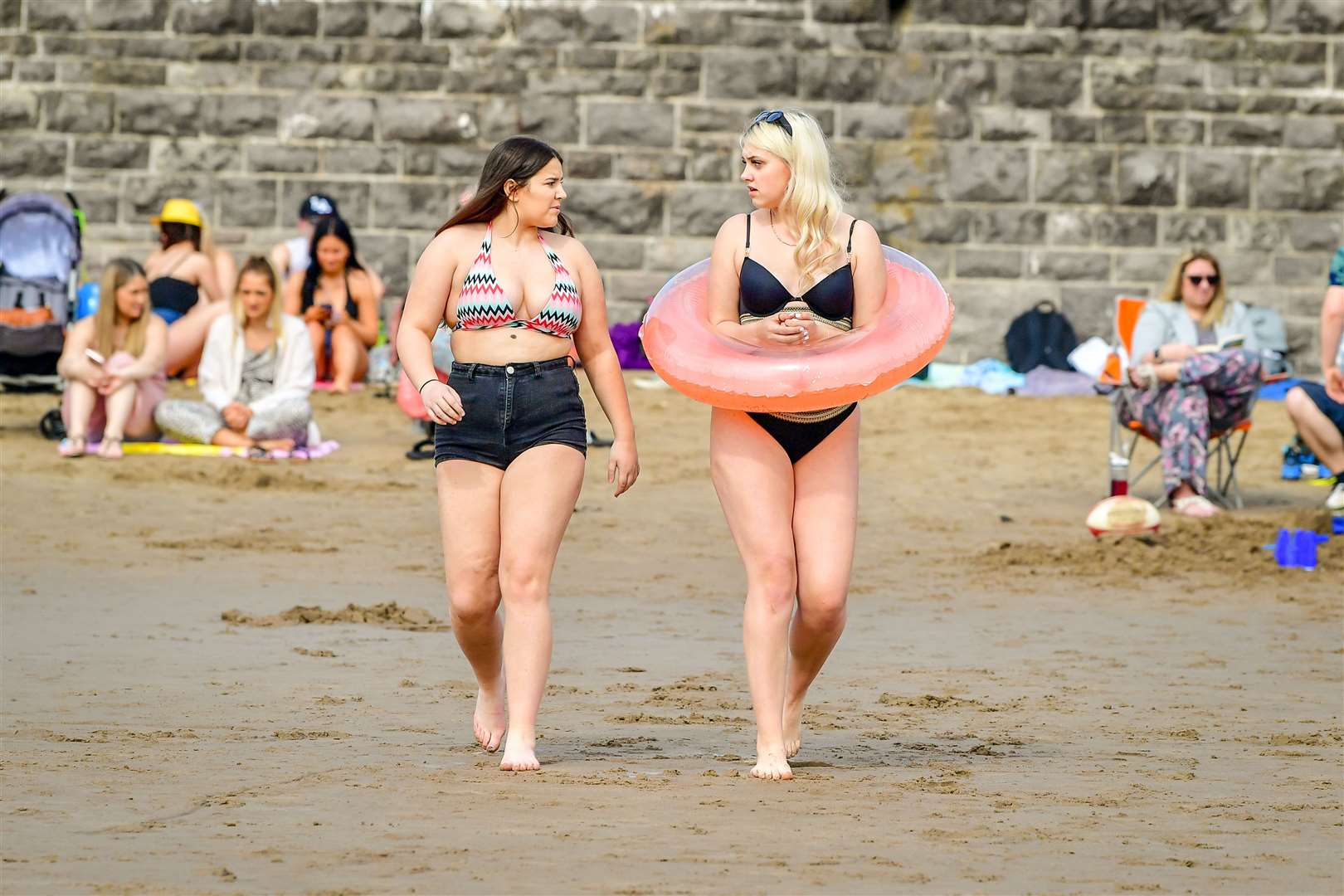 People making the most of the warmer weather at Barry Island beach (Ben Birchall/PA)