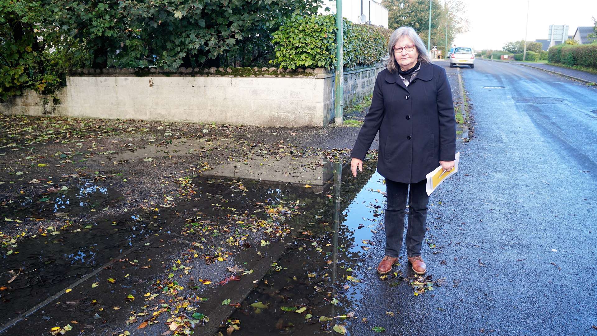 Councillor Jan McEwan shows one of several blocked drains in the village of Watten. This one is sited on Station Road. Picture: DGS