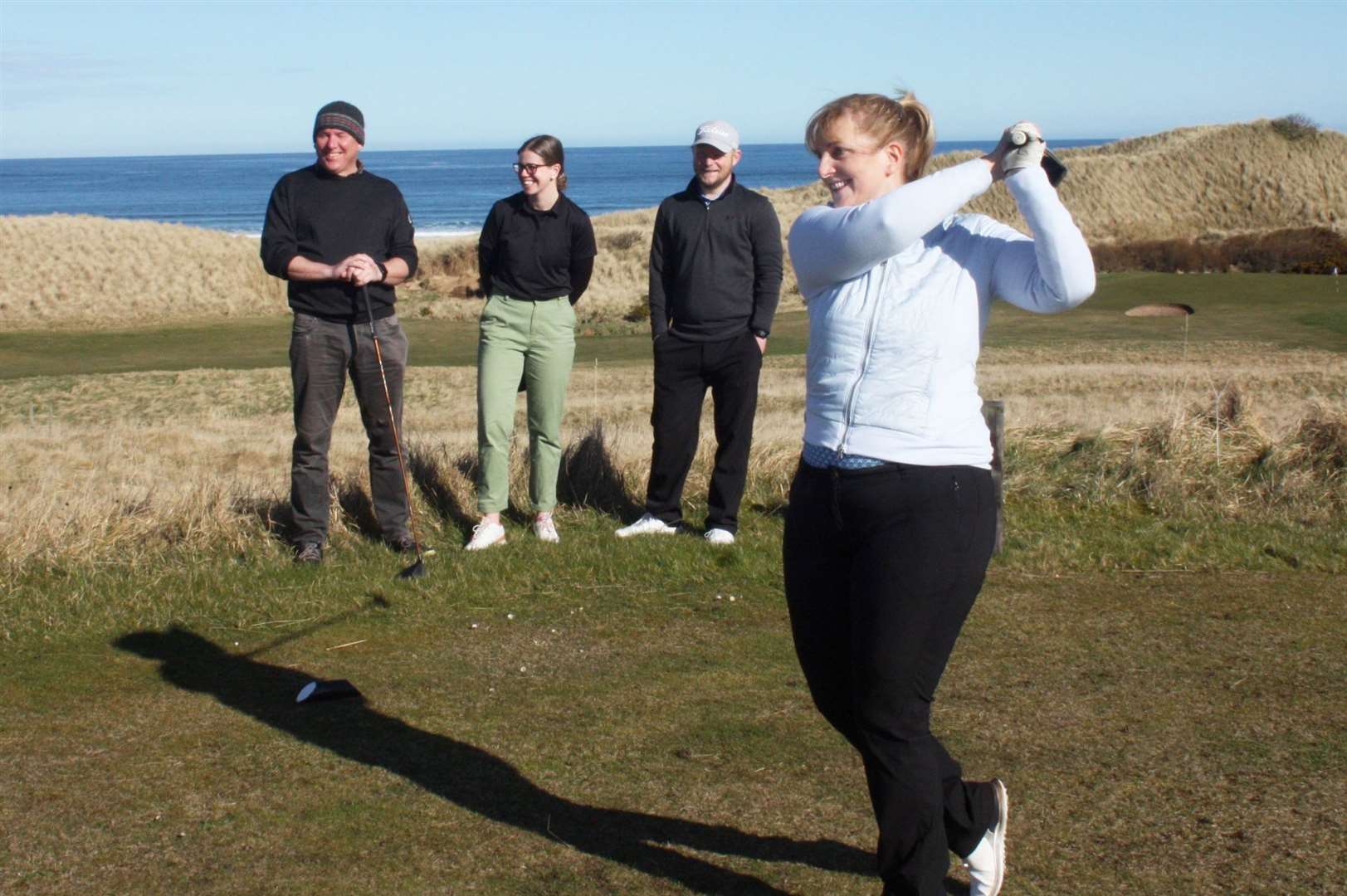 Reay captain Carol Paterson hits the first tee shot of the summer season, while looking on are (from left) Steve Efemey, Rebecca Munro and Jason Norwood.