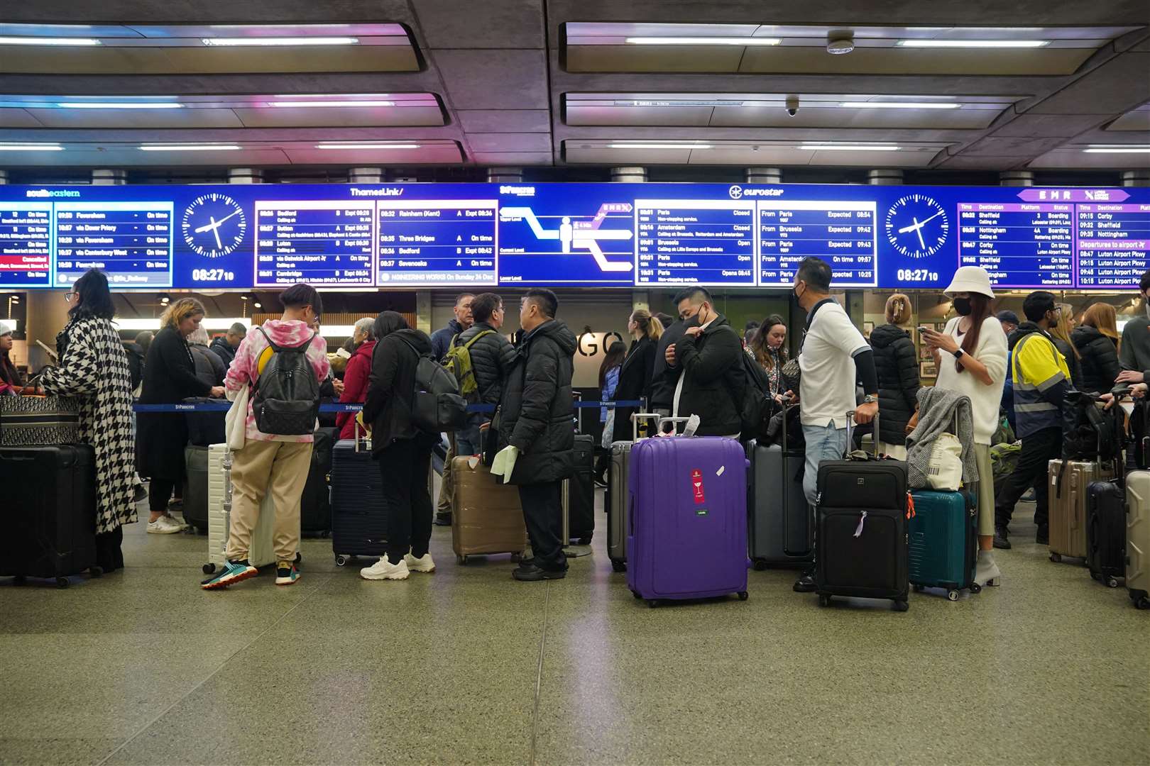 Passengers queue at St Pancras International station in London as Christmas getaway disruption is expected to continue (Lucy North/PA)