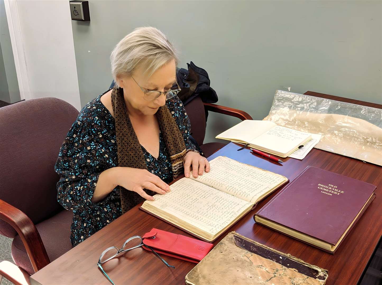 Dr Lynne Tammi pictured in November 2023 at Brockville [Ontario] Cemetery Archives, researching the names of traveller children buried in Quarrier's Homes unmarked graves. The children had been sent abroad as part of a forced assmililation of gypsies as part of the 'Tinker Experiment'.