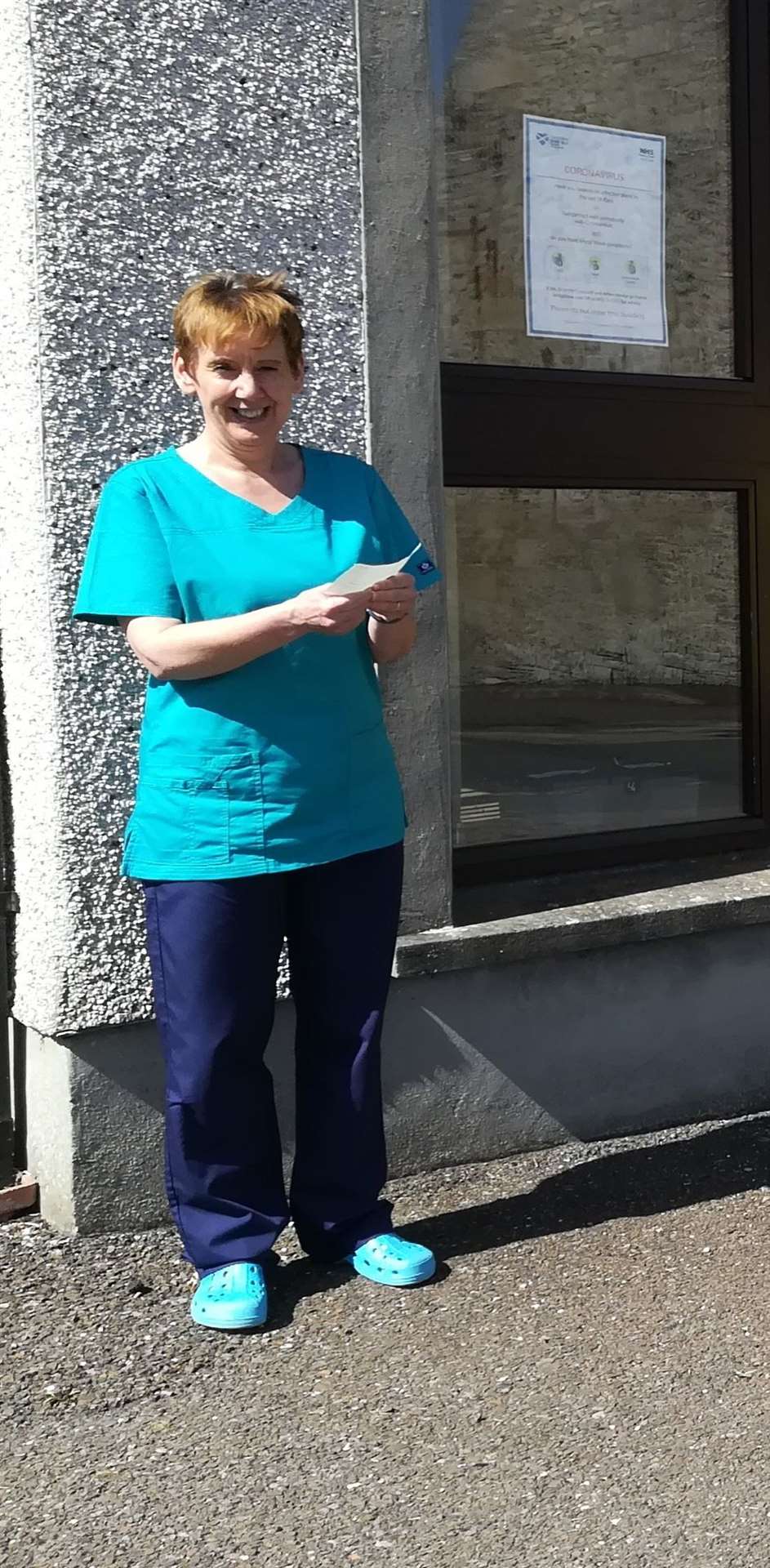 Dr Alison Brooks outside the Princes Street surgery after a recent cheque presentation from Thurso RNLI crew members.