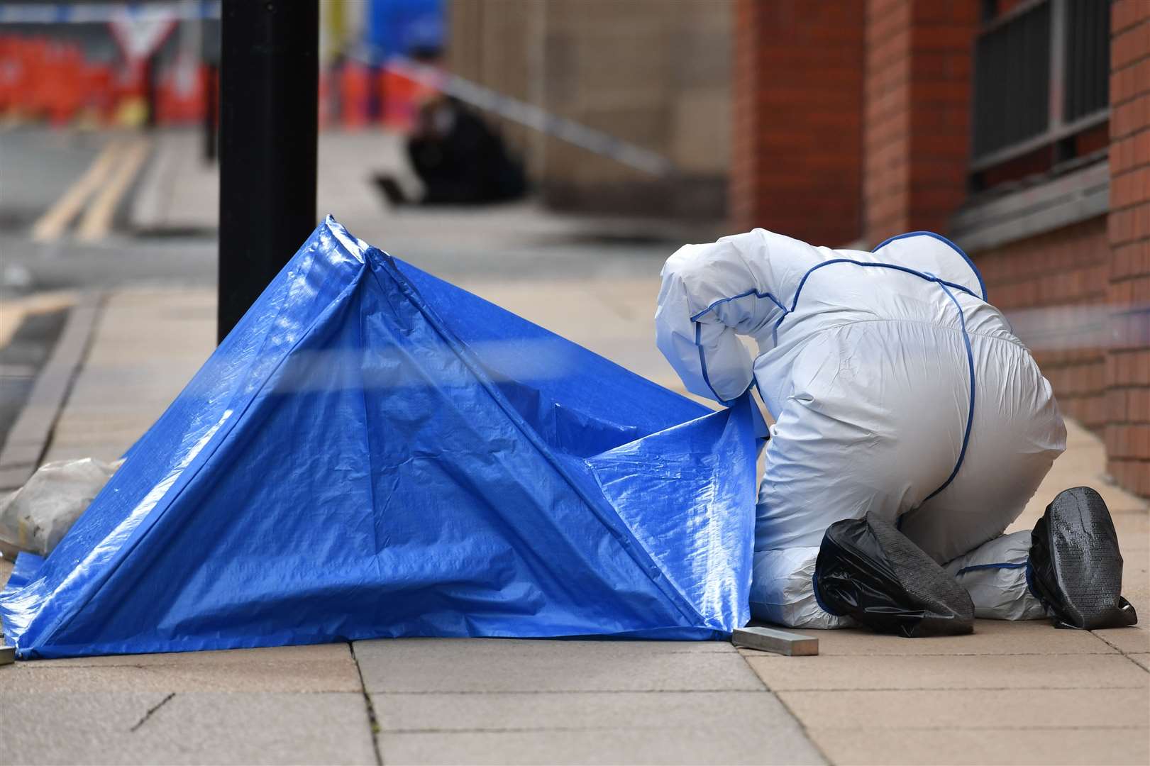 Police forensics officers are in the area, including on Livery Street (Jacob King/PA)