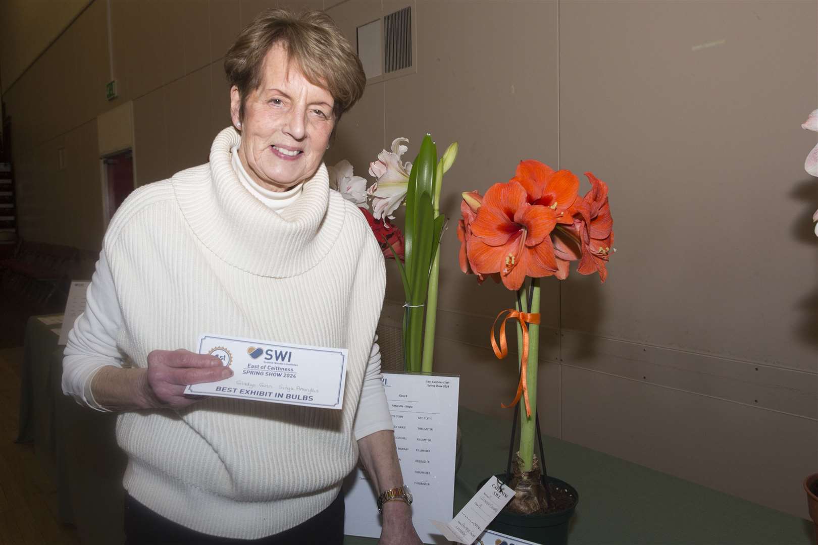 Gladys Gunn, Mid Clyth, with her amaryllis that won her the best exhibit trophy at the East of Caithness SWI bulb show. Picture: Robert MacDonald