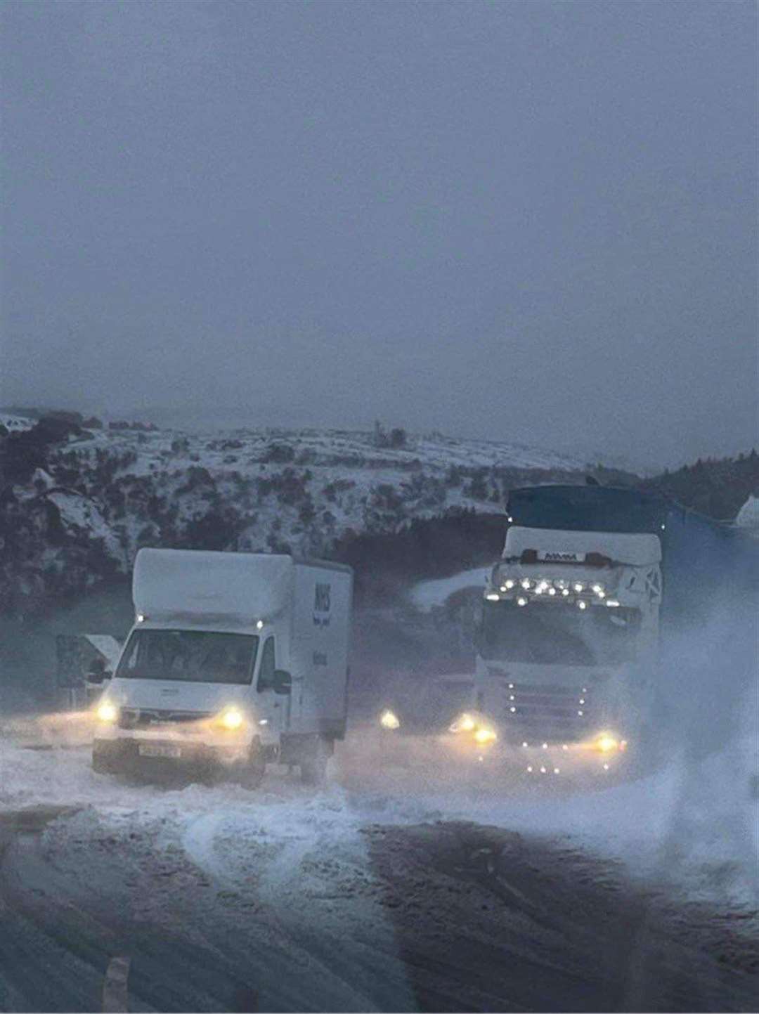 A lorry and NHS van stuck in snow drifts on Berriedale Braes on Wednesday. Picture: Andrew Ritchie