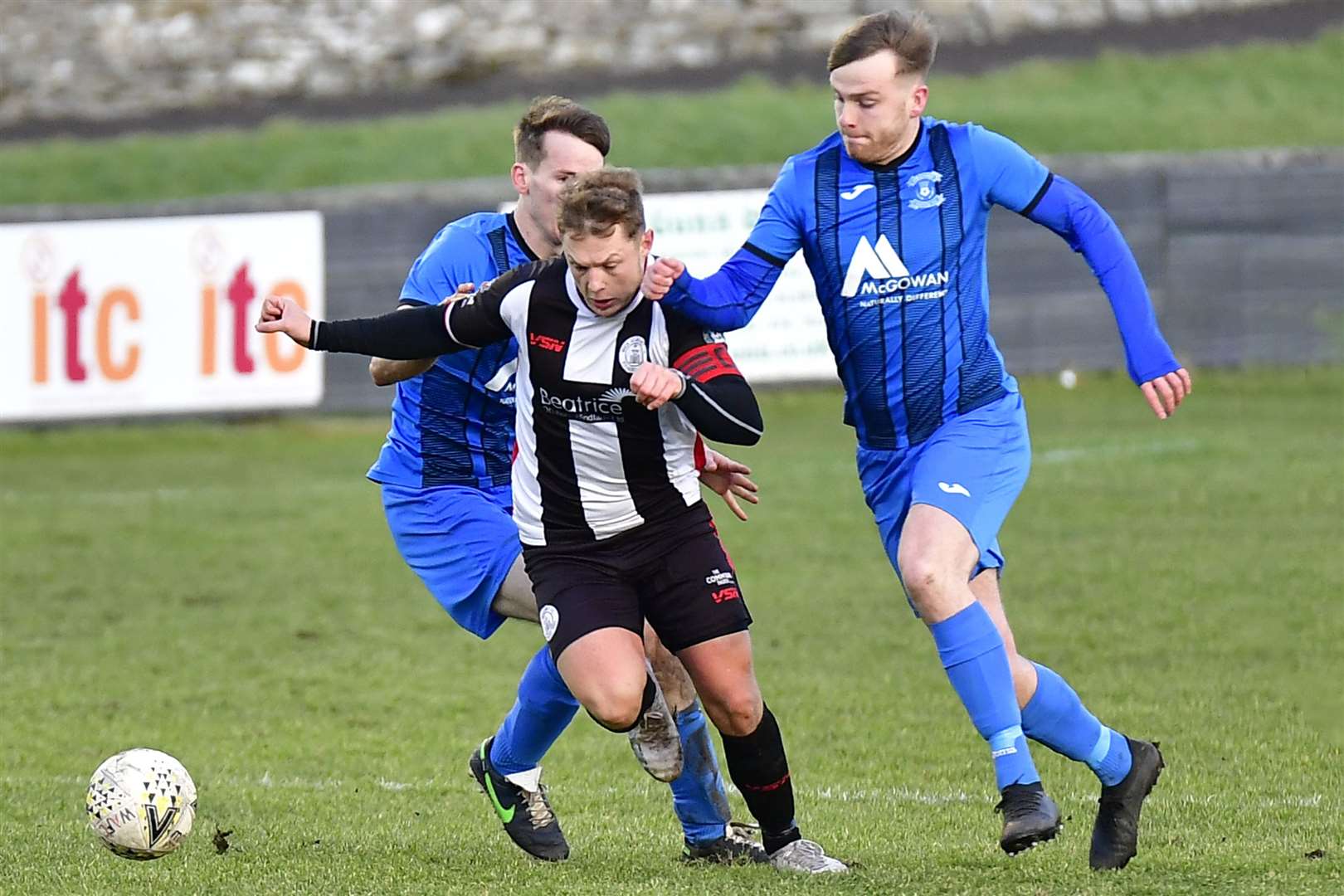 Wick Academy's Jack Halliday goes through a gap between Strathspey pair Daniel Whitehorn and Michael McKenzie. Picture: Mel Roger