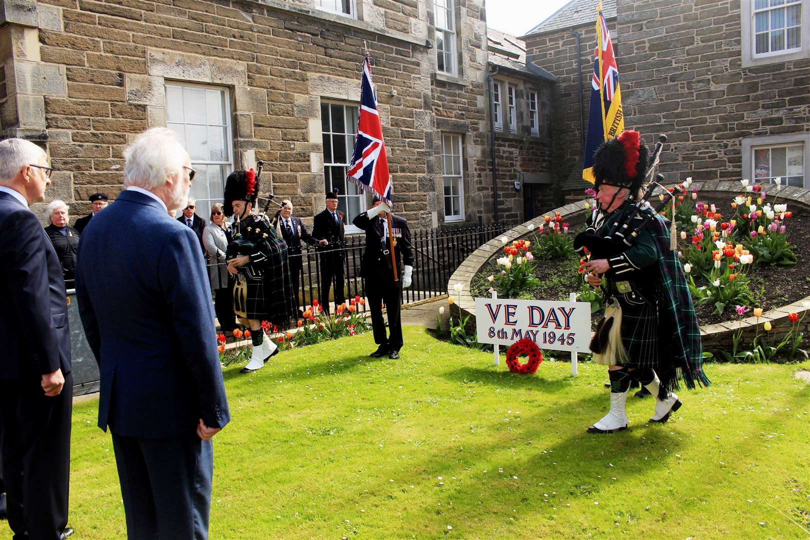 Pipers Gordon Tait and Alasdair Miller leaving the garden of remembrance at the end of the VE Day ceremony. Picture: Alan Hendry