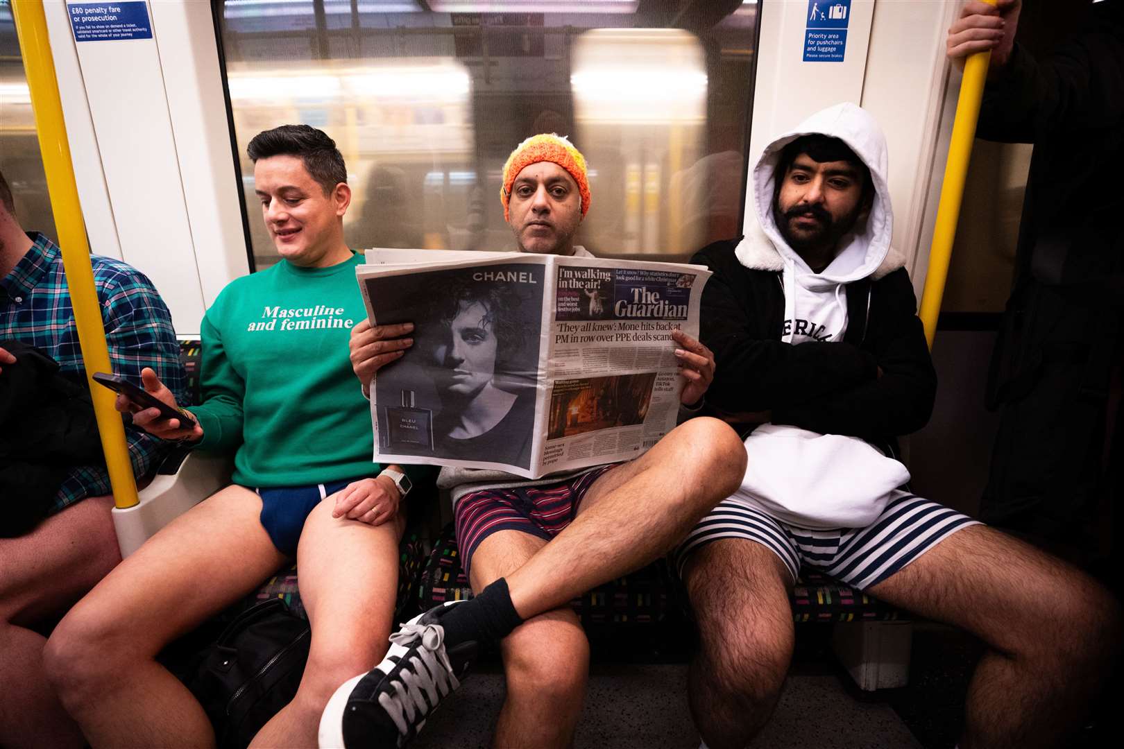 People riding a Circle line Tube as they take part in the annual No Trousers Tube Ride in London (James Manning/PA)