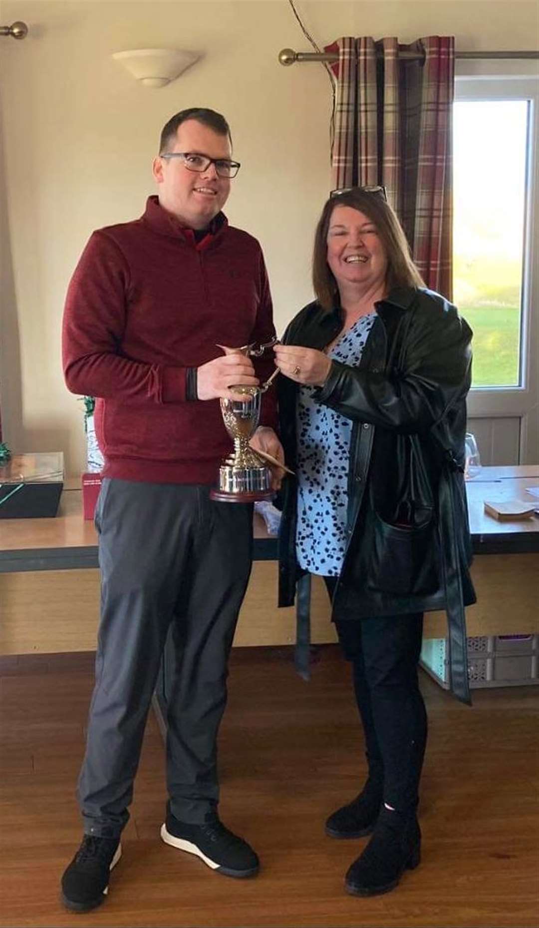 Ronnie Campbell Open winner Brent Munro receiving the trophy from Maryjane Campbell, wife of the late Ronnie Campbell.