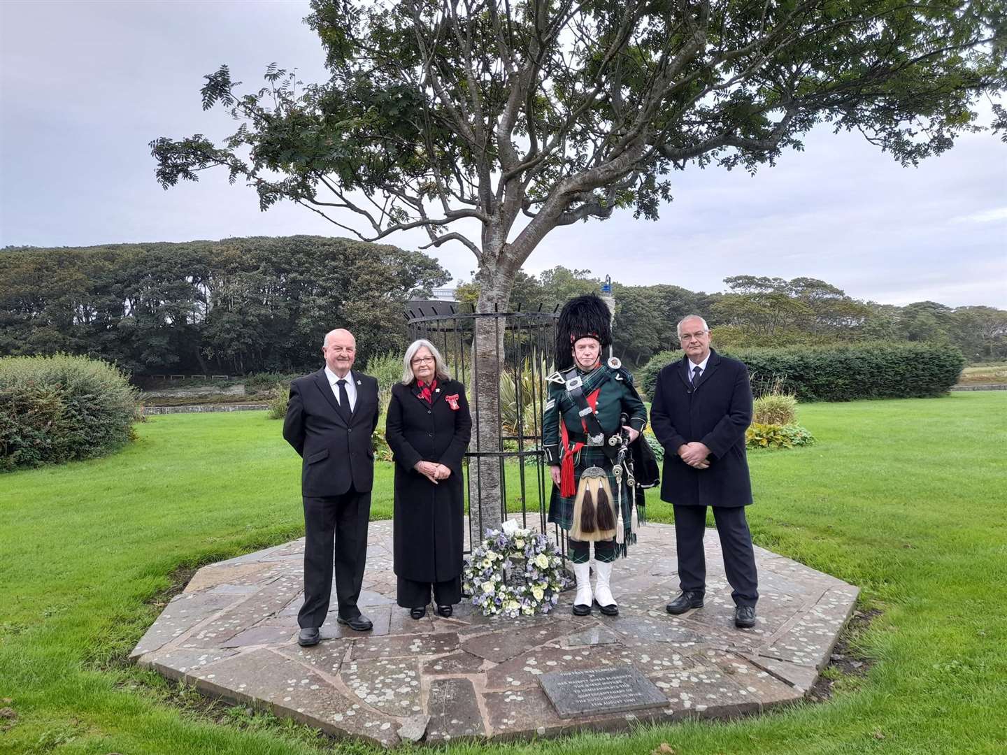Provost Jan McEwan and councillors Willie Mackay (left) and Raymond Bremner with piper Alasdair Miller after the laying of the wreath at the garden of remembrance at Wick riverside.