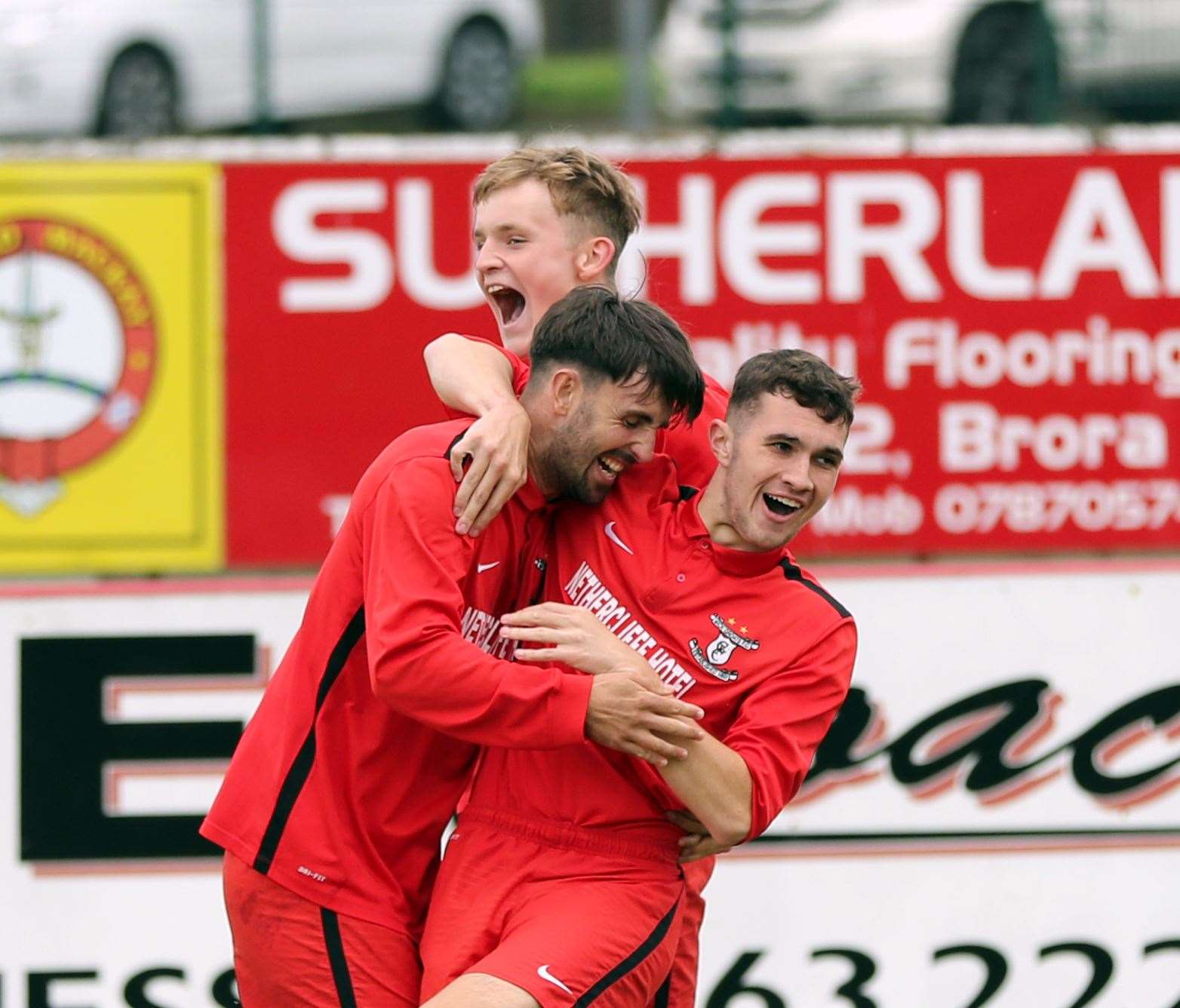 Ben Sinclair gives Graham MacNab a hug after the latter had scored an early winner for Wick Groats in their Highland Amateur Cup final win against Avoch. Picture: James Gunn