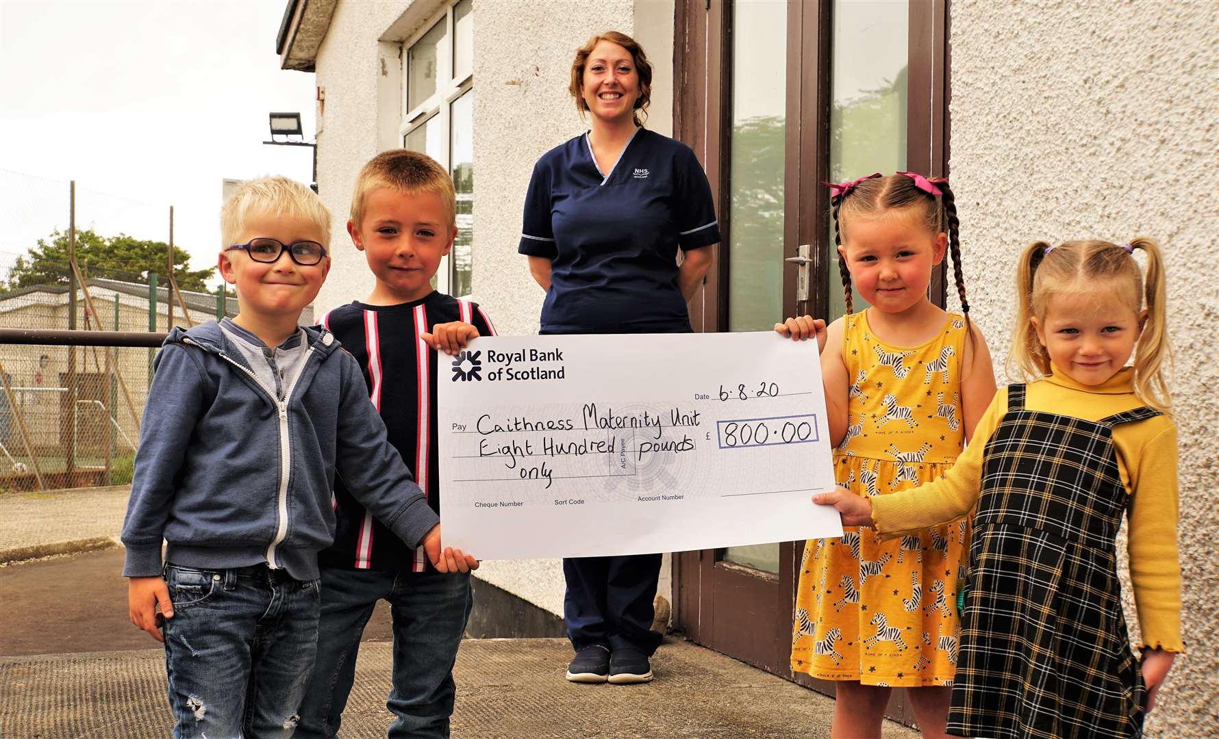 Handing over the £800 cheque are (from left) Dan, Harrison, Kinley and Lucy. Interim senior charge midwife Cara Birnie, at the rear, accepted the money on behalf of the hospital. Picture: DGS