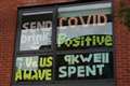 ‘Let us out’: Isolating students hang window protest signs