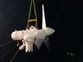 The turbine is hoisted into the air ahead of its installation.