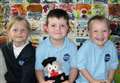 New primary one pupils face the camera