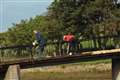 Two of the Wick Paths Group team painting railings on the main bridge.