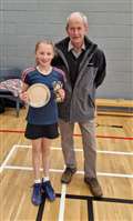 Under-11 girls' singles winner Sophie Mackay with tournament sponsor Ronald Mackay.