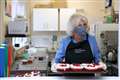 Camilla praises volunteers as she serves lunch to pensioners