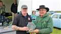 Receiving the Tom Sayles Trophy for best restored or modified vehicle from Kevin Sutherland, left, was George Williamson from Scarfskerry with a 1973 Bedford TK lorry. Picture: DGS
