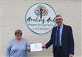 Certificate handed over to long-serving Wick Healing Hub volunteer